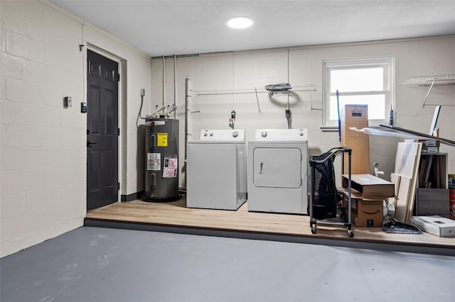 clothes washing area featuring separate washer and dryer and water heater