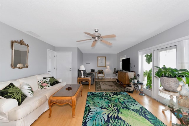 living room with hardwood / wood-style floors and ceiling fan