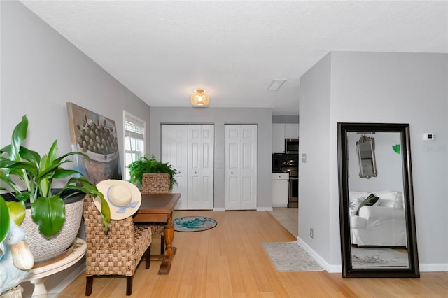 entryway featuring light hardwood / wood-style floors and a textured ceiling