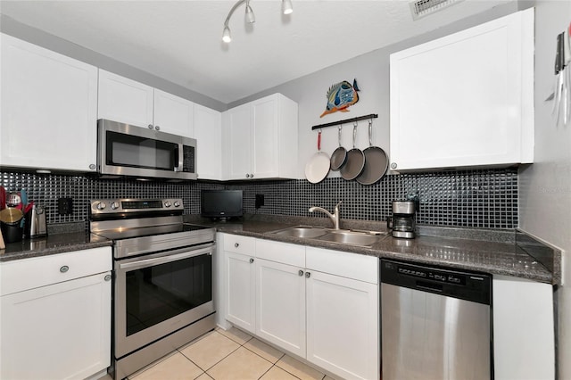 kitchen with white cabinetry, sink, backsplash, and stainless steel appliances