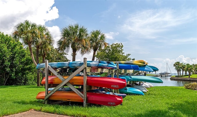 view of jungle gym with a water view and a lawn