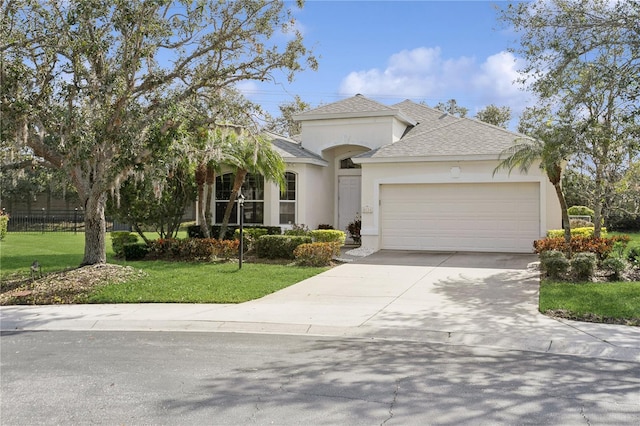 view of front of property featuring a garage and a front yard