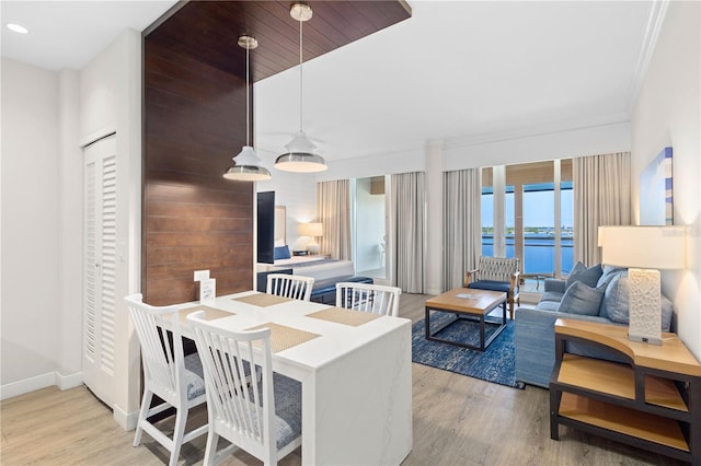 dining area featuring hardwood / wood-style flooring and crown molding