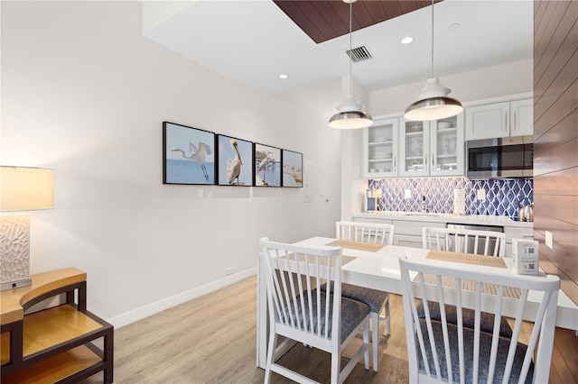 dining room featuring sink and light hardwood / wood-style flooring