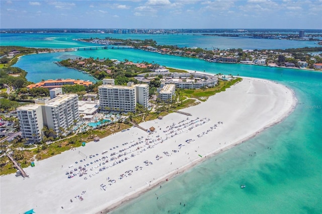 birds eye view of property featuring a water view and a beach view