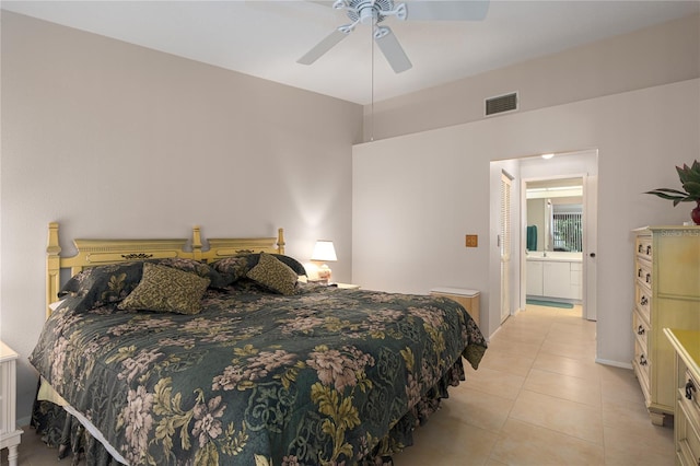 tiled bedroom with ensuite bath and ceiling fan