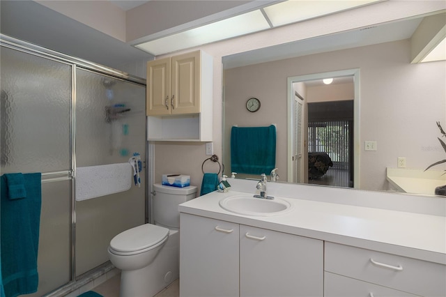 bathroom featuring vanity, toilet, and an enclosed shower