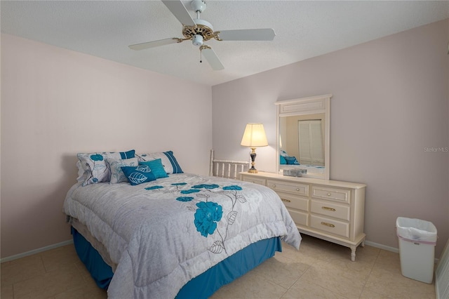 tiled bedroom featuring a textured ceiling and ceiling fan