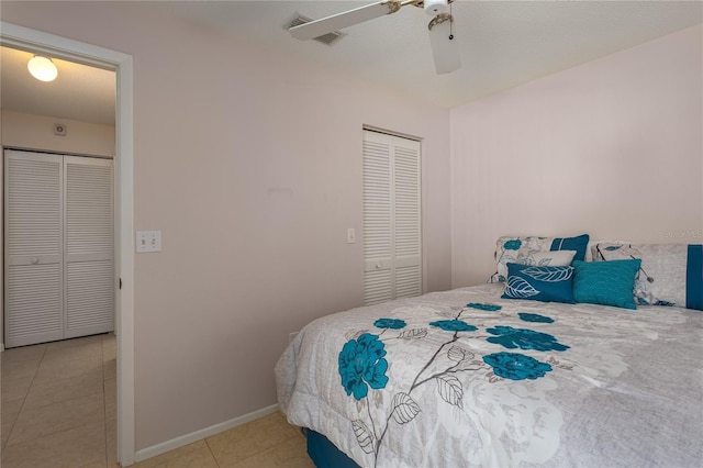 tiled bedroom with a closet and ceiling fan