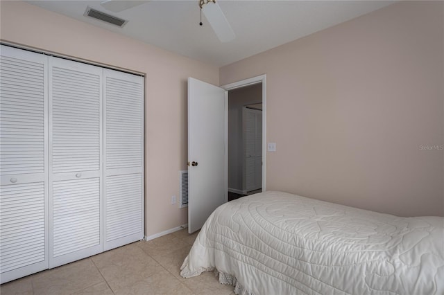 bedroom with light tile patterned floors, a closet, and ceiling fan