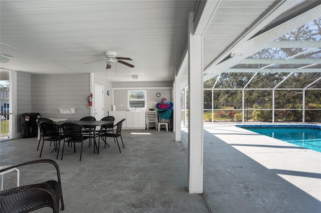 view of patio / terrace featuring a lanai, an outdoor bar, and ceiling fan