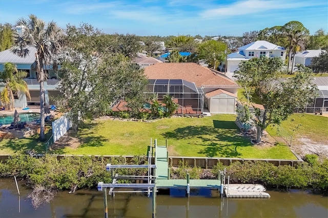 dock area featuring a water view, boat lift, a residential view, and a lawn
