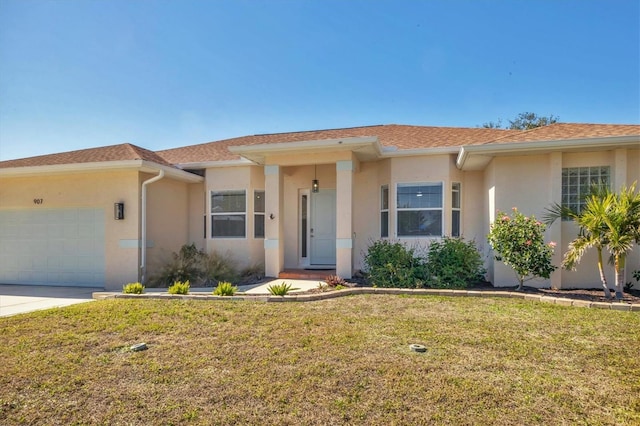 ranch-style house with a garage, stucco siding, a front yard, and concrete driveway