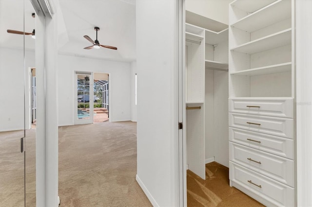 spacious closet with light carpet and a ceiling fan