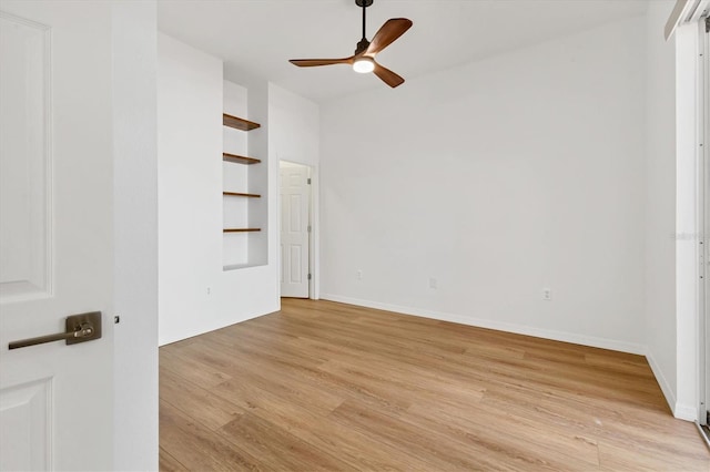 unfurnished bedroom with light wood-style flooring, baseboards, and a ceiling fan