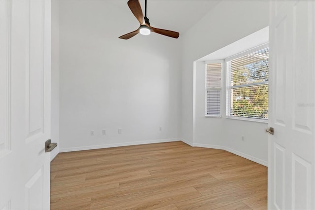 spare room featuring light wood-style flooring, ceiling fan, and baseboards