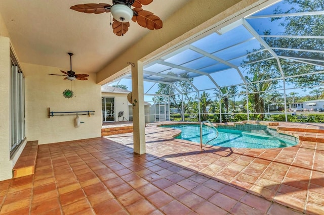 outdoor pool featuring ceiling fan, a patio, and glass enclosure