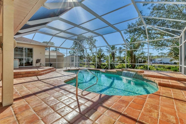 outdoor pool with a storage unit, a patio, an outbuilding, and a lanai