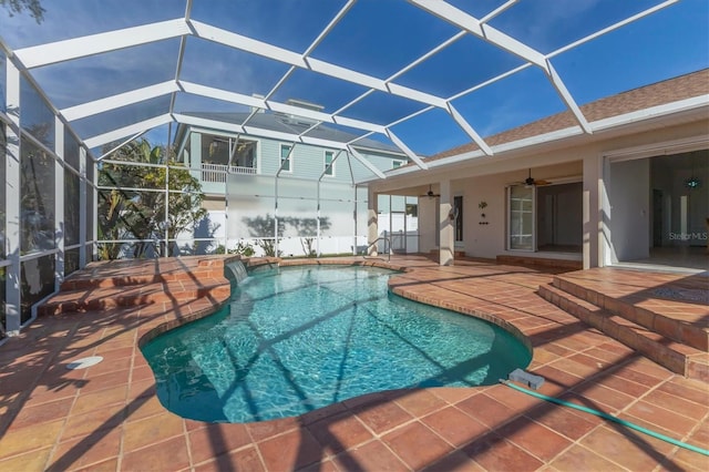 swimming pool featuring a patio area, a ceiling fan, and glass enclosure