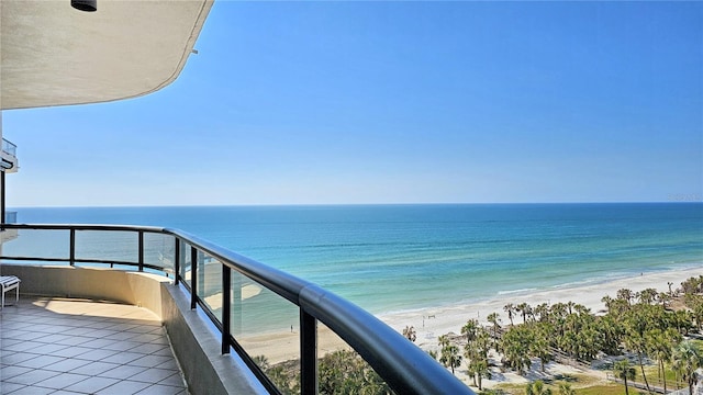 balcony featuring a water view and a view of the beach