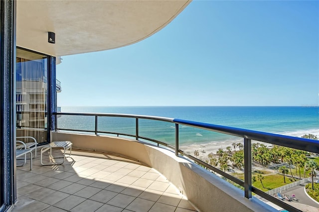 balcony with a beach view and a water view