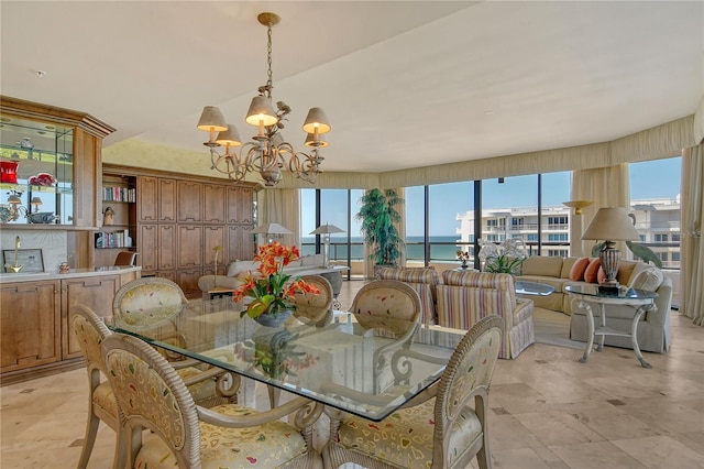 dining area featuring a water view and a chandelier