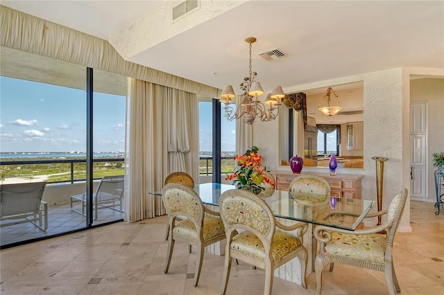 dining space featuring an inviting chandelier and a wealth of natural light