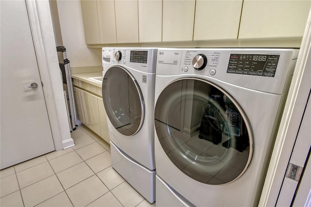 clothes washing area with independent washer and dryer, mail boxes, and light tile patterned floors