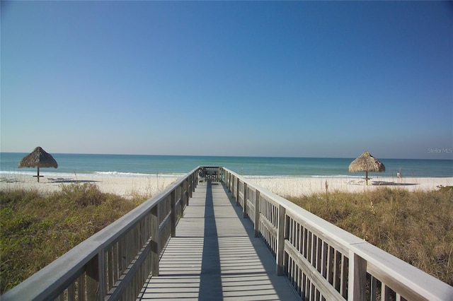 surrounding community with a view of the beach and a water view