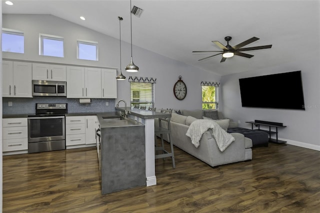 kitchen featuring sink, white cabinetry, decorative light fixtures, dark hardwood / wood-style floors, and stainless steel appliances