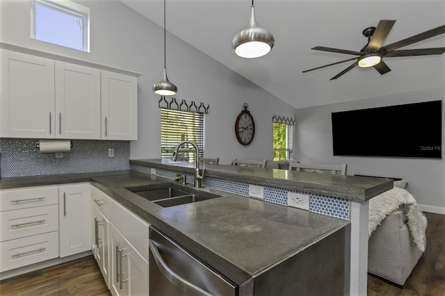 kitchen with white cabinetry, sink, hanging light fixtures, stainless steel dishwasher, and kitchen peninsula