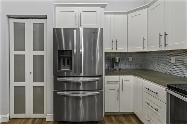 kitchen featuring stainless steel appliances, tasteful backsplash, and white cabinets