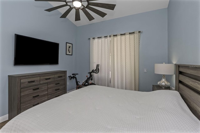 bedroom with hardwood / wood-style flooring, lofted ceiling, and ceiling fan