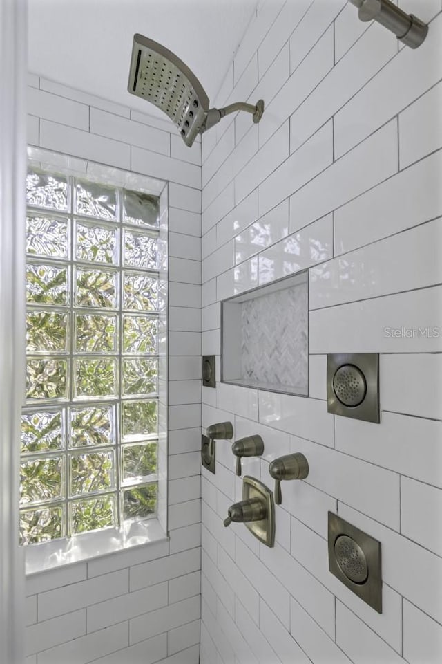 bathroom with a tile shower