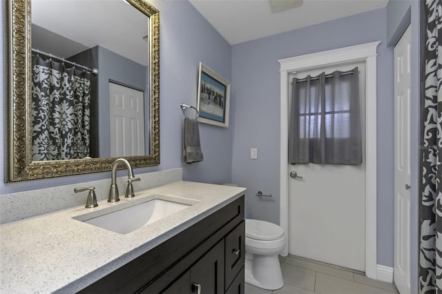 bathroom with vanity, toilet, and tile patterned flooring