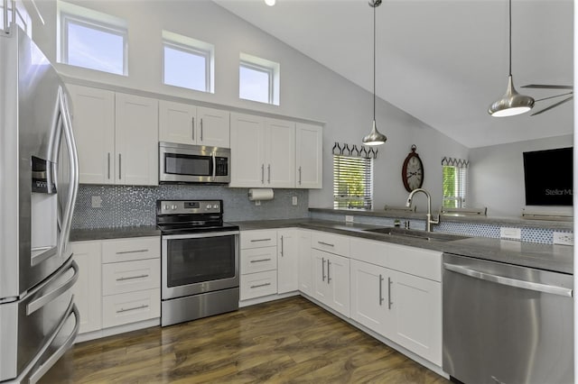 kitchen with sink, stainless steel appliances, hanging light fixtures, and white cabinets