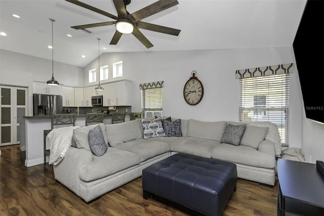 living room with ceiling fan, dark hardwood / wood-style floors, and high vaulted ceiling