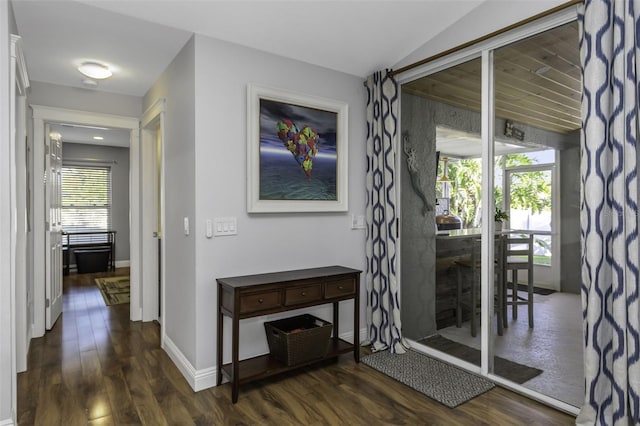 corridor featuring lofted ceiling and dark hardwood / wood-style floors