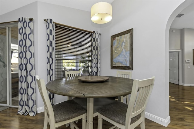 dining area featuring plenty of natural light and dark hardwood / wood-style floors