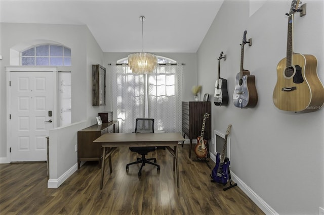 office space featuring lofted ceiling, dark hardwood / wood-style floors, and a chandelier