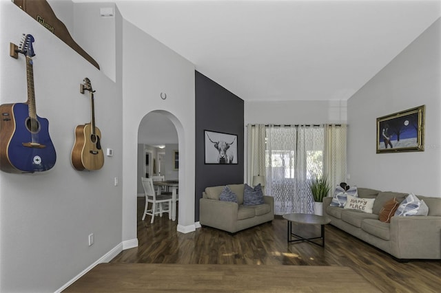 living room featuring dark wood-type flooring and high vaulted ceiling