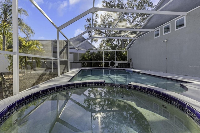 view of swimming pool featuring glass enclosure