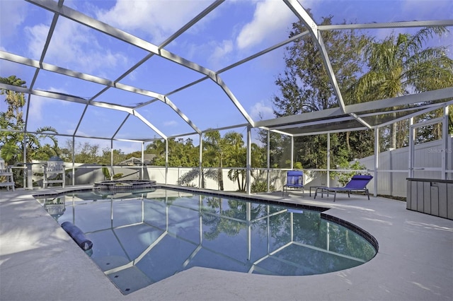 view of swimming pool with an in ground hot tub, a lanai, and a patio area