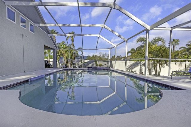 view of pool featuring glass enclosure and a patio area