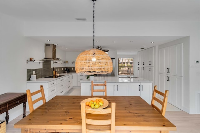 dining space with sink and light hardwood / wood-style flooring