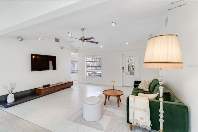 living room featuring ceiling fan and lofted ceiling