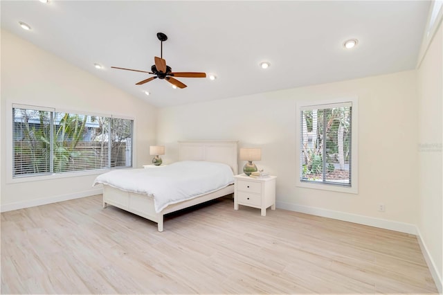 bedroom with ceiling fan, vaulted ceiling, and light hardwood / wood-style flooring