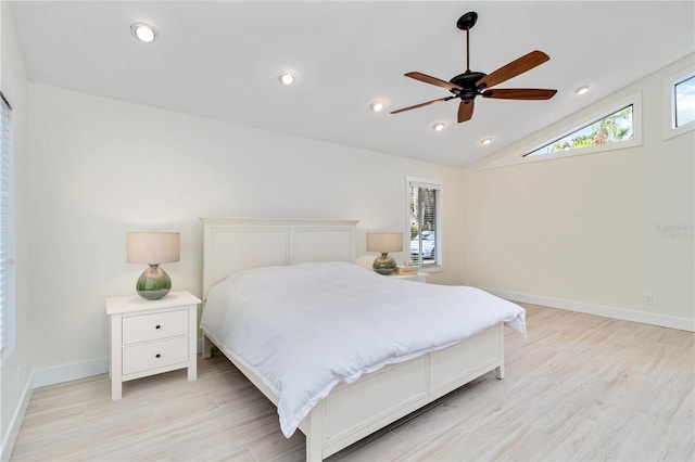 bedroom featuring ceiling fan, lofted ceiling, and light hardwood / wood-style flooring