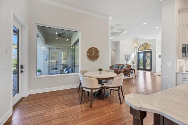 dining area featuring recessed lighting, a healthy amount of sunlight, light wood-style flooring, and baseboards