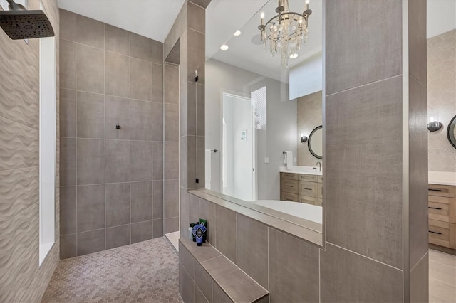 full bathroom featuring a walk in shower, vanity, and a notable chandelier